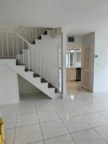 a view of entryway and kitchen