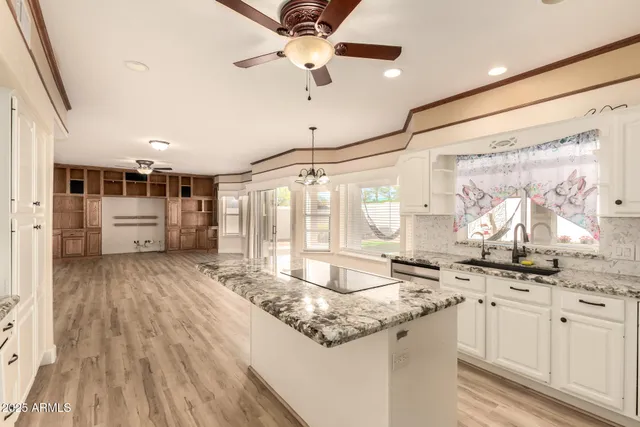 a kitchen with stainless steel appliances granite countertop a sink and cabinets