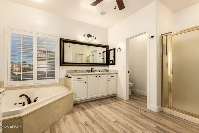 a bathroom with a tub sink and mirror