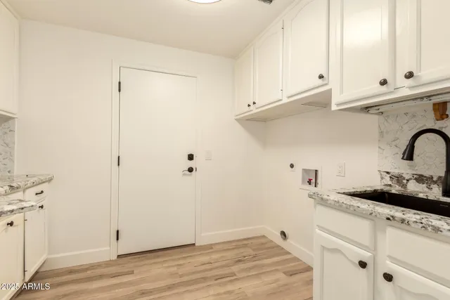 a kitchen with stainless steel appliances white cabinets and a sink