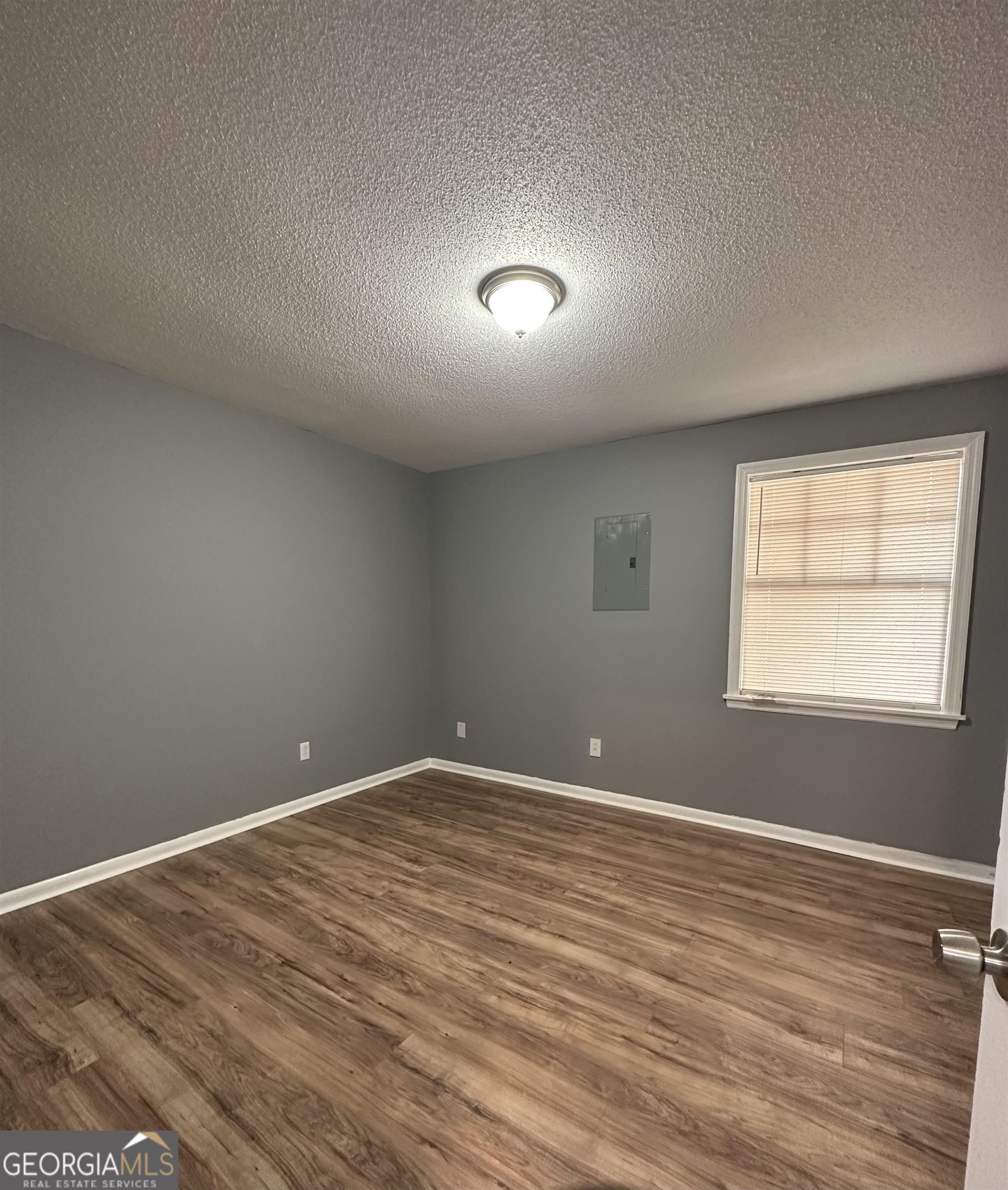 2843 Lumpkin Road, Unit A Augusta, GA 30906 - Photo 3 of 7 an empty room with wooden floor and windows