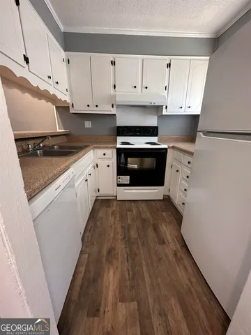 a kitchen with stainless steel appliances a stove a sink and a refrigerator