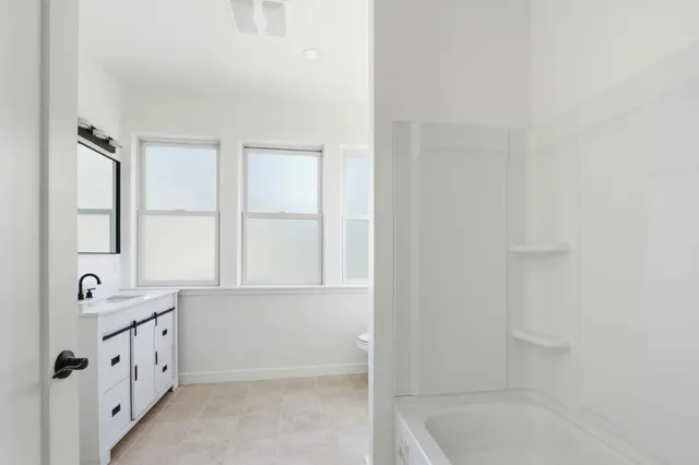 a bathroom with a double vanity sink and mirror