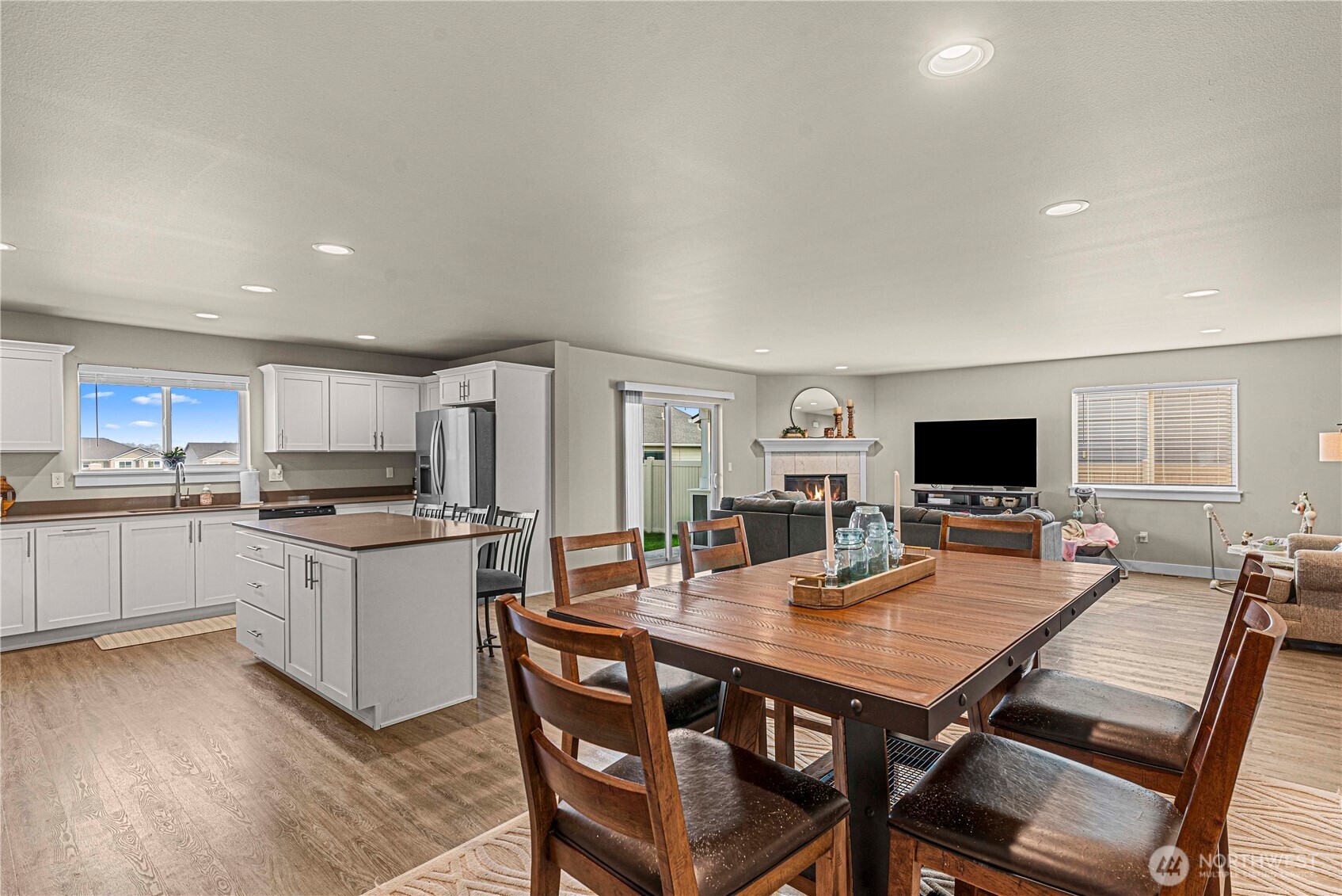 183 Emma Drive Wenatchee, WA 98801 - Photo 13 of 34 a living room with stainless steel appliances furniture a flat screen tv and a dining table