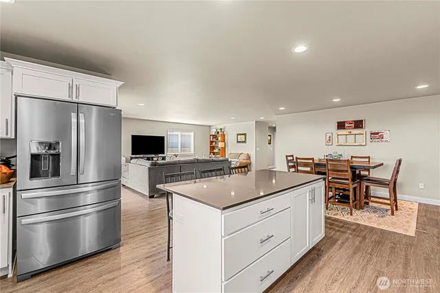 a kitchen with a refrigerator and a stove top oven