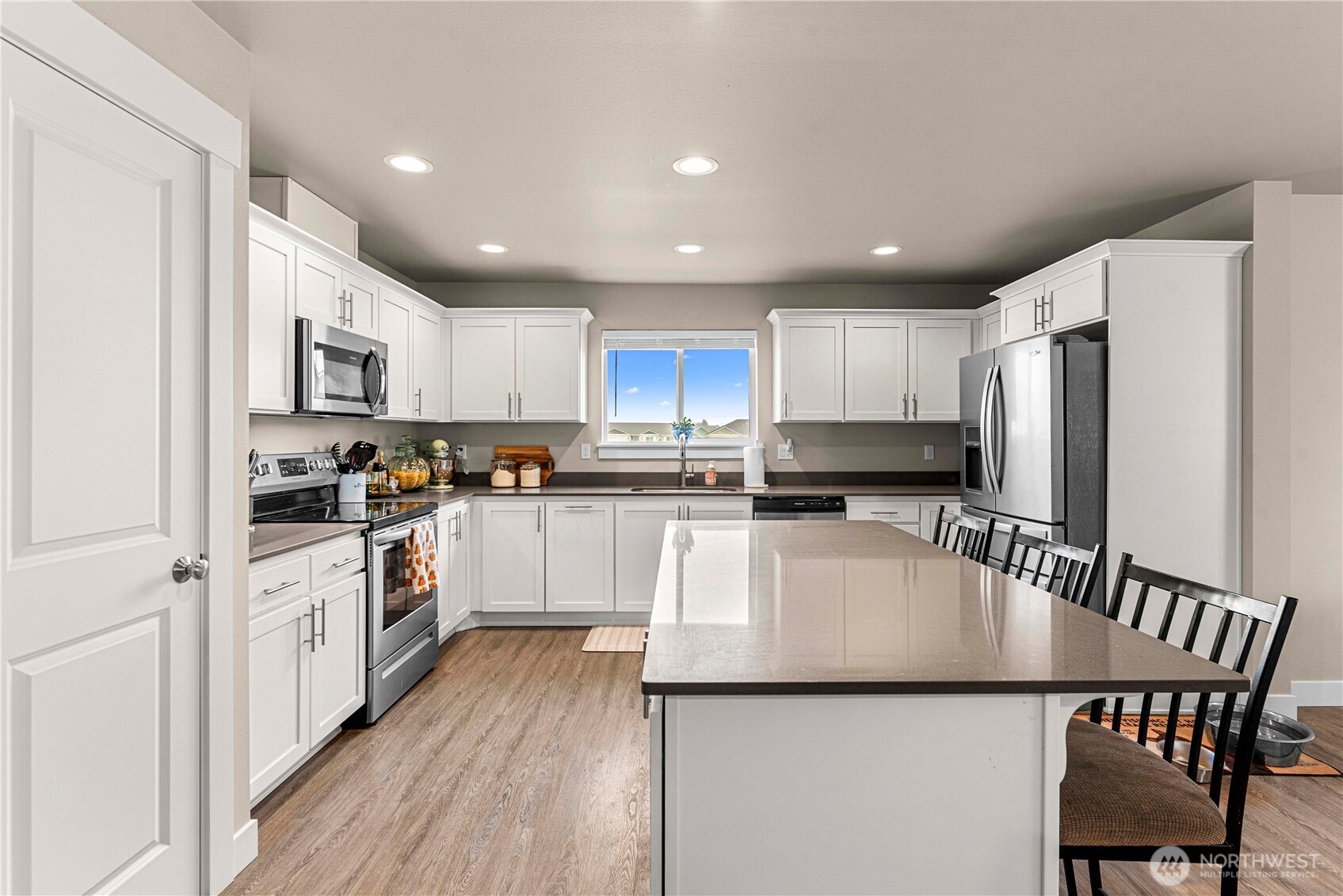 183 Emma Drive Wenatchee, WA 98801 - Photo 19 of 34 a kitchen with stainless steel appliances granite countertop a refrigerator a stove a sink a dining table and chairs