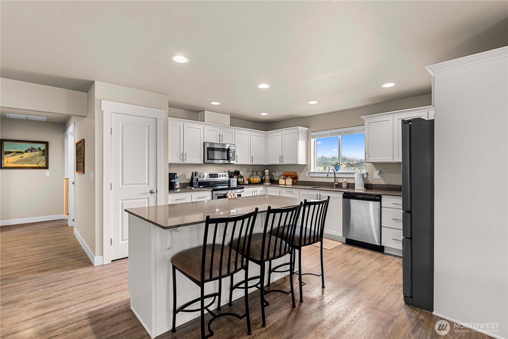 183 Emma Drive Wenatchee, WA 98801 - Photo 20 of 34 a kitchen with stainless steel appliances granite countertop a table chairs refrigerator sink a stove a microwave and cabinets