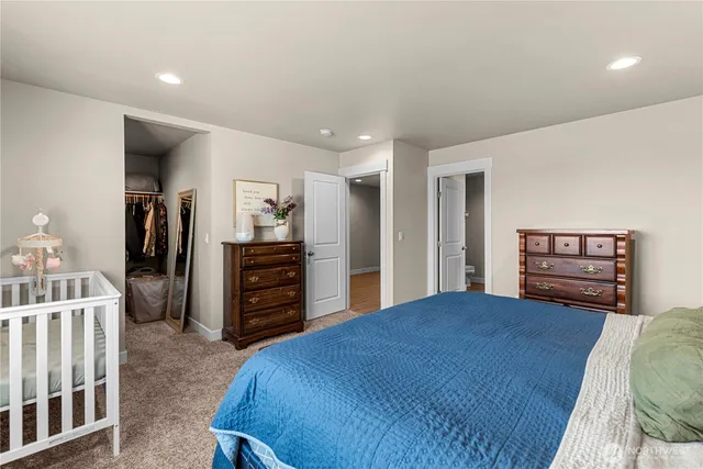 a bedroom with a bed and a television