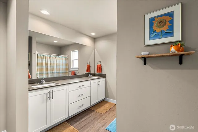 a hall with a sink and a mirror