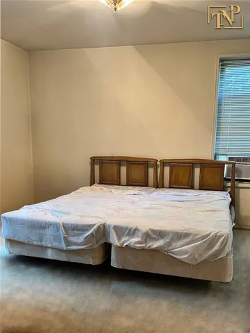 a bedroom with a bed and lamp