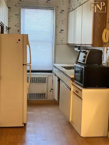 a kitchen with a refrigerator and a stove