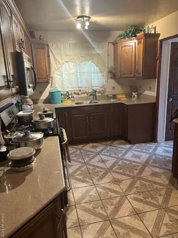 a kitchen with a sink appliances and cabinets