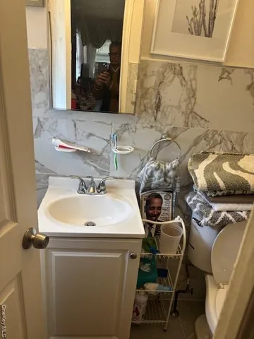 a bathroom with a sink toilet and mirror
