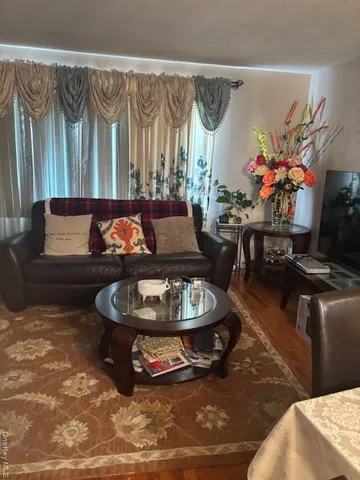 a living room filled with furniture and a large window