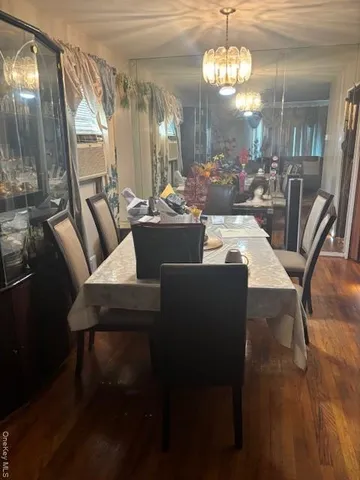 a view of a dining room with furniture and a chandelier