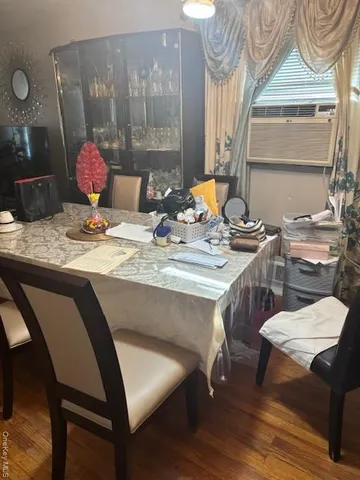 a dining room with furniture and wooden floor