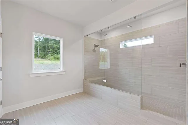 a bathroom with a shower and a tub