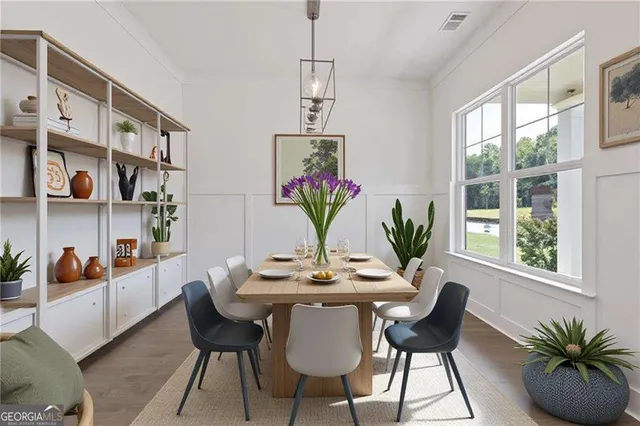 a view of a dining room with furniture and window