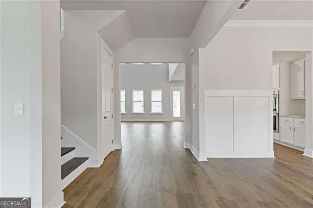 a view of gallery with wooden floor