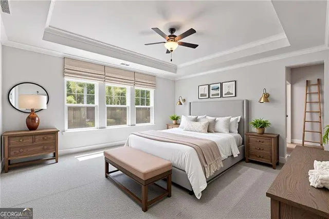 a spacious bedroom with a bed a chandelier and a large window