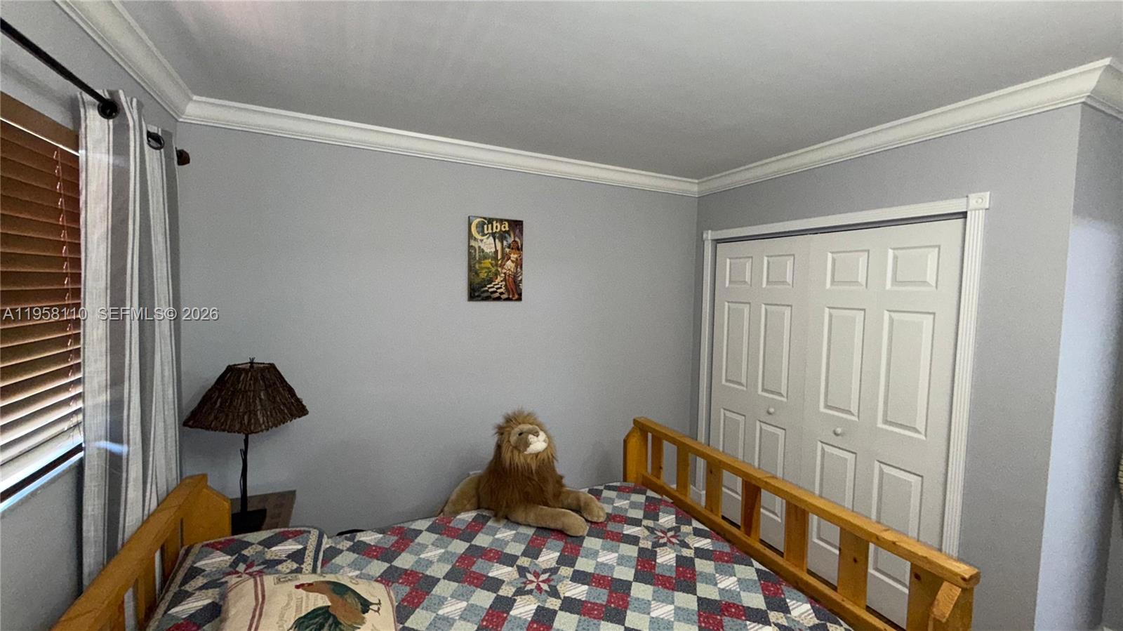 1075 West 68th Street, Unit 403 Hialeah, FL 33014 - Photo 12 of 25 a bedroom with a bed and a window