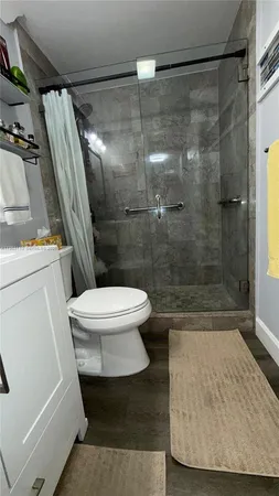 a bathroom with a shower and a toilet