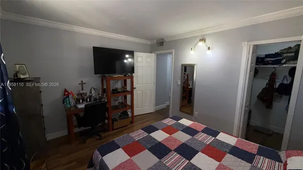 a bedroom with a bed and a walk in closet
