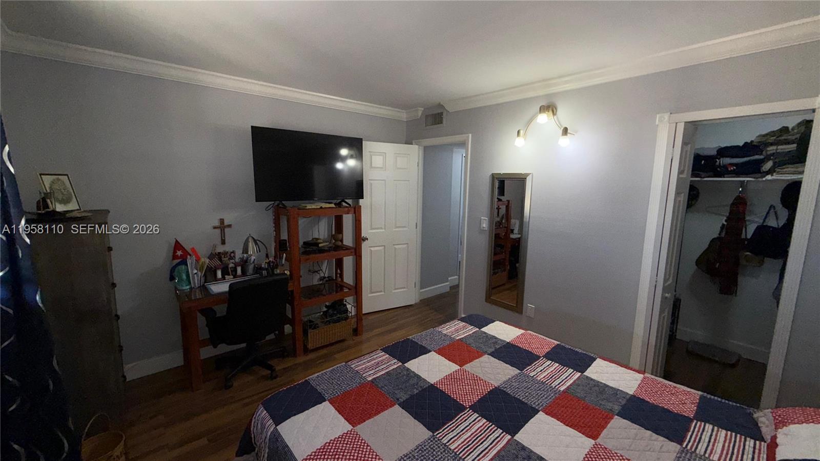 1075 West 68th Street, Unit 403 Hialeah, FL 33014 - Photo 15 of 25 a bedroom with a bed and a walk in closet