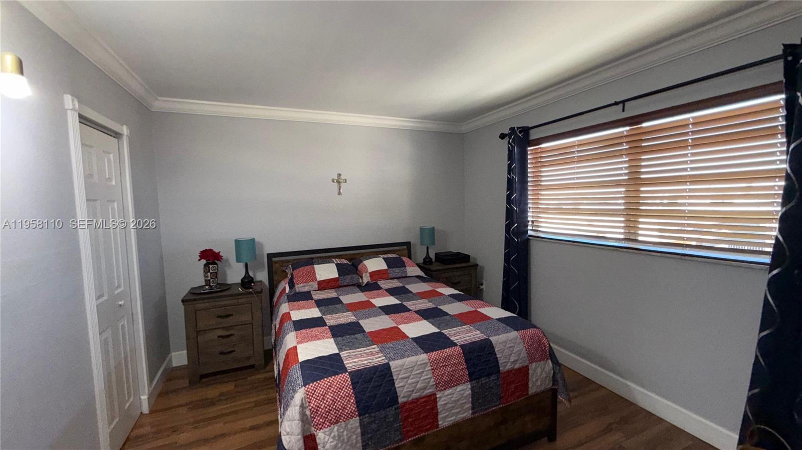 1075 West 68th Street, Unit 403 Hialeah, FL 33014 - Photo 17 of 25 a bedroom with a bed and a window