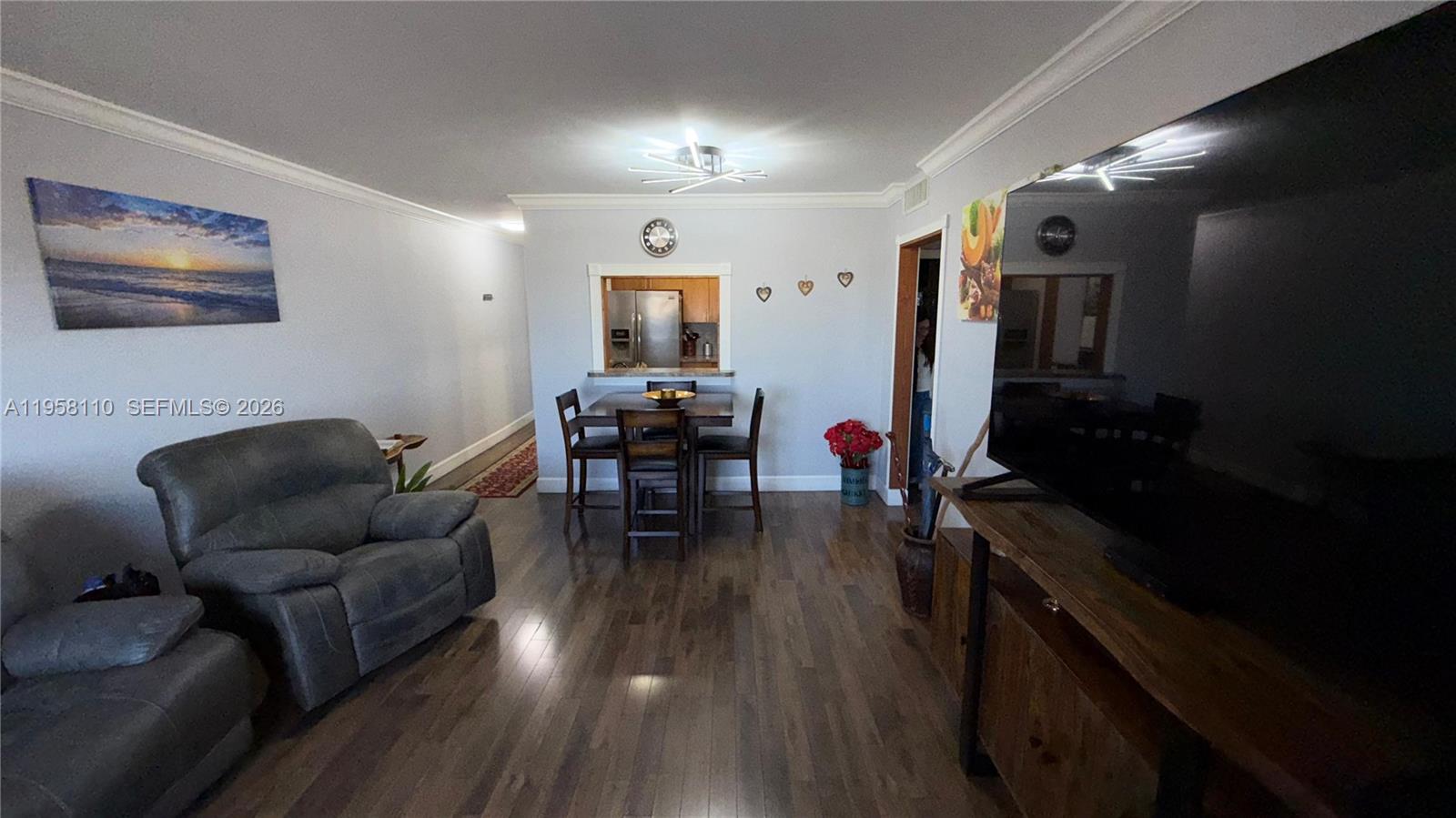 1075 West 68th Street, Unit 403 Hialeah, FL 33014 - Photo 4 of 25 a living room with furniture and wooden floor