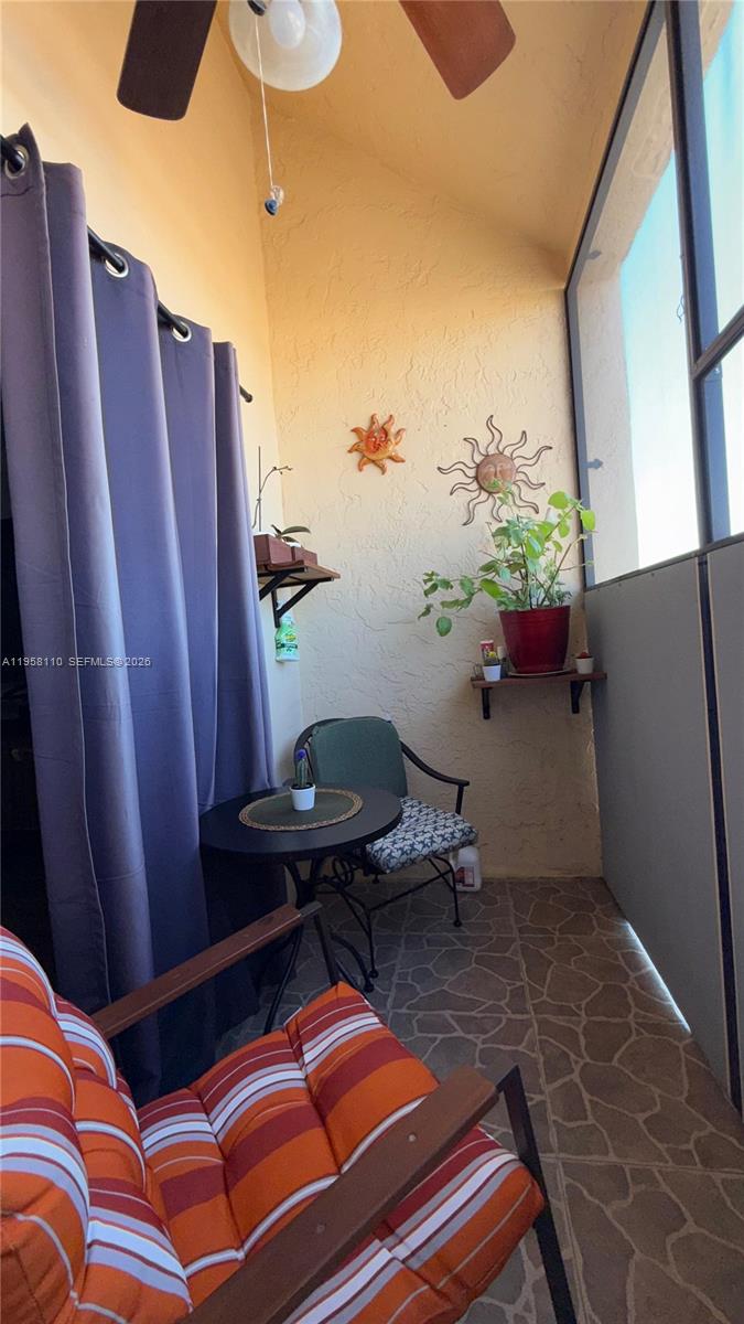 1075 West 68th Street, Unit 403 Hialeah, FL 33014 - Photo 9 of 25 a bed room with furniture and a window