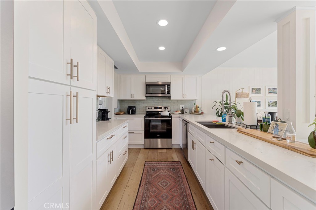 4326 Via Verde Cypress, CA 90630 - Photo 20 of 43 a kitchen with granite countertop white cabinets and white appliances
