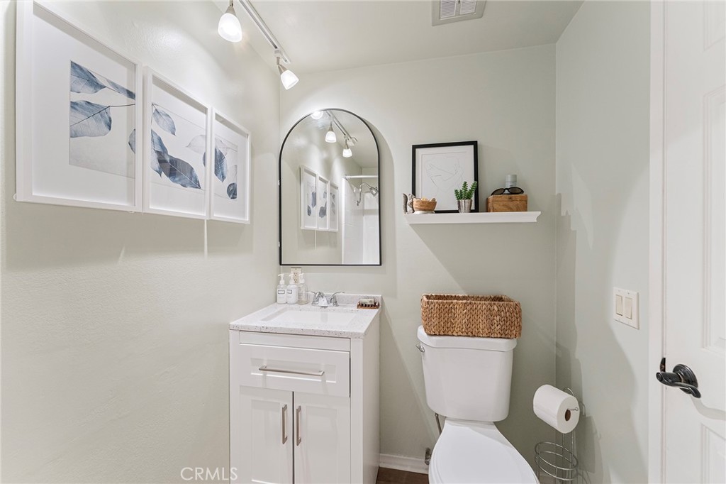 4326 Via Verde Cypress, CA 90630 - Photo 29 of 43 a bathroom with a toilet a sink and mirror