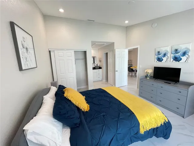 a bedroom with a bed and a television