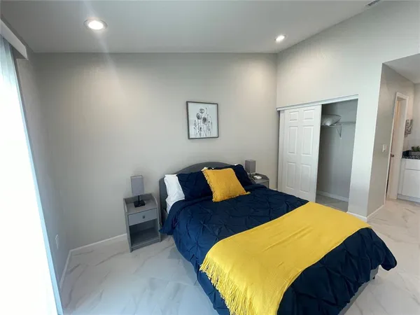 a bedroom with a bed and a painting