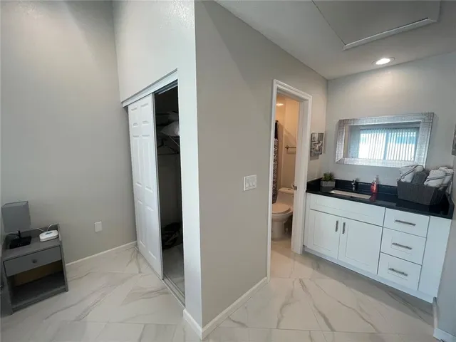 a large bathroom with a sink and a mirror