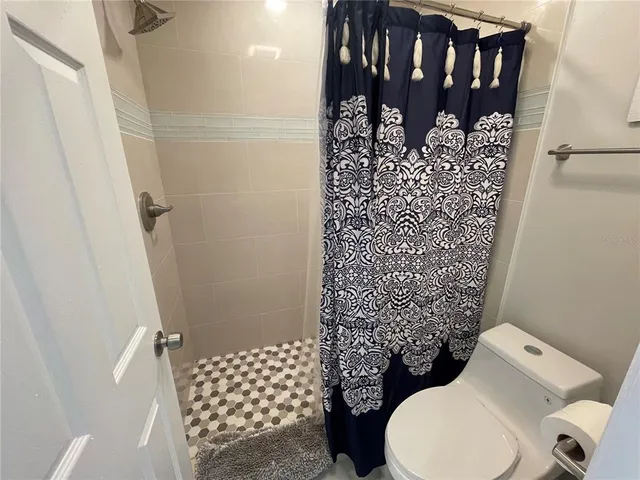 a bathroom with a toilet and shower