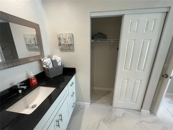 a room with a sink and a mirror