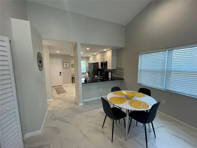 a view of a dining room with furniture and a chandelier
