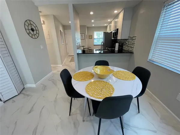 a kitchen with a table chairs and a kitchen view