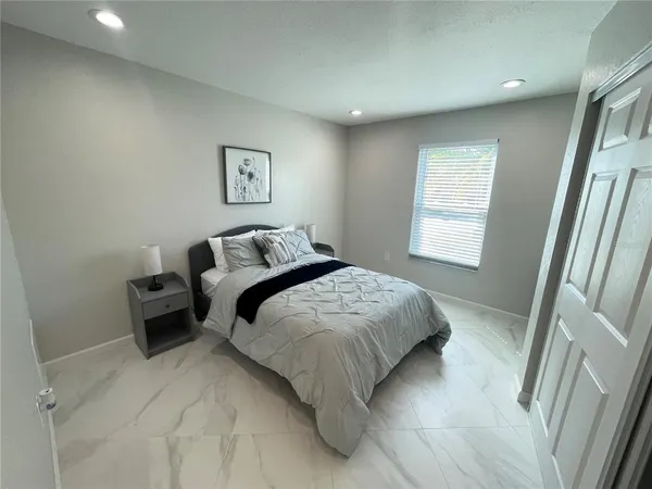 a bedroom with a bed and a window