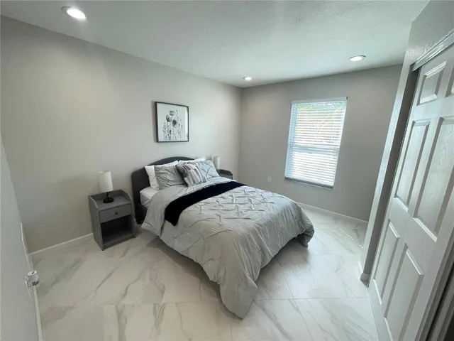 a bedroom with a bed and a window