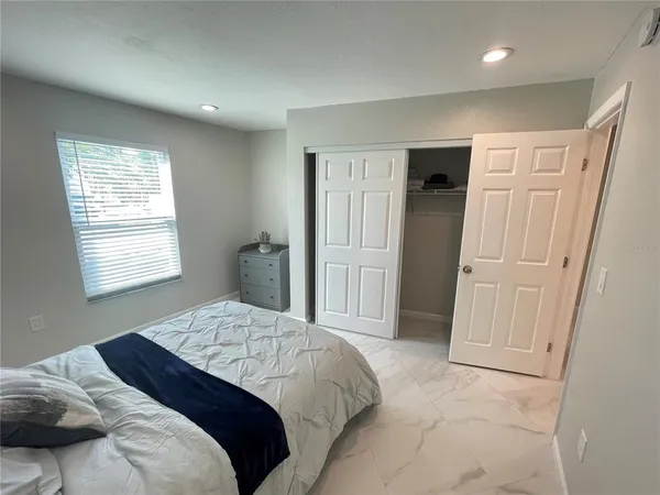 a bedroom with a bed and a window