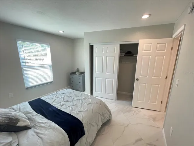 a bedroom with a bed and a window