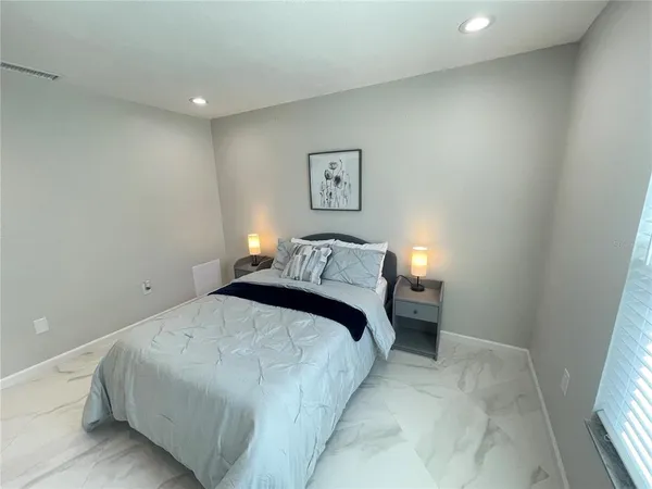 a bedroom with a bed and a window