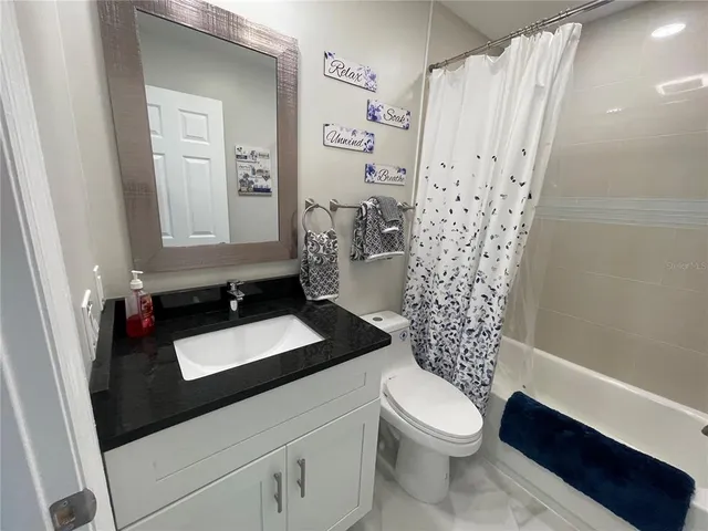 a view of backyard with outdoor seating and wooden fence