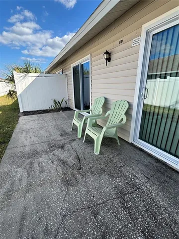 a view of a patio with table and chairs and potted plants