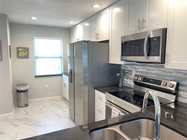 a kitchen with a refrigerator and a sink