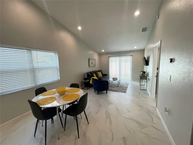a living room with furniture a table and a window