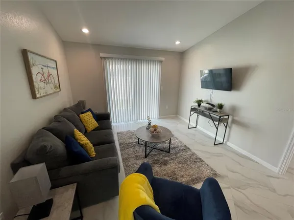 a living room with furniture and a flat screen tv